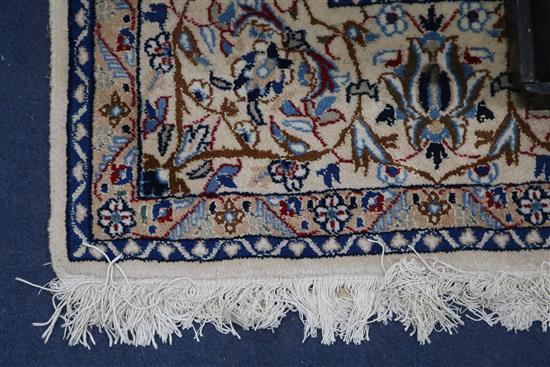 A Persian cream ground rug 270 x 165cm